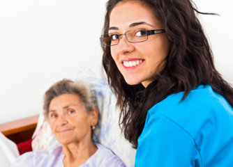 nurse and her senior woman patient in the bed