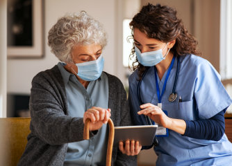 nurse and senior woman patient looking at the tablet