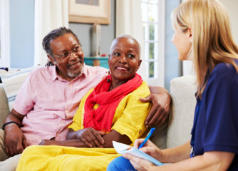 senior couple talking to a nurse