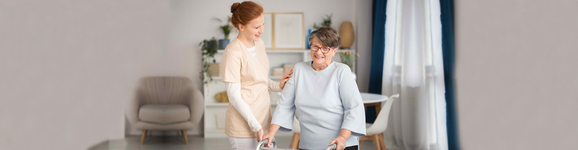 caregiver assisting senior woman stand up